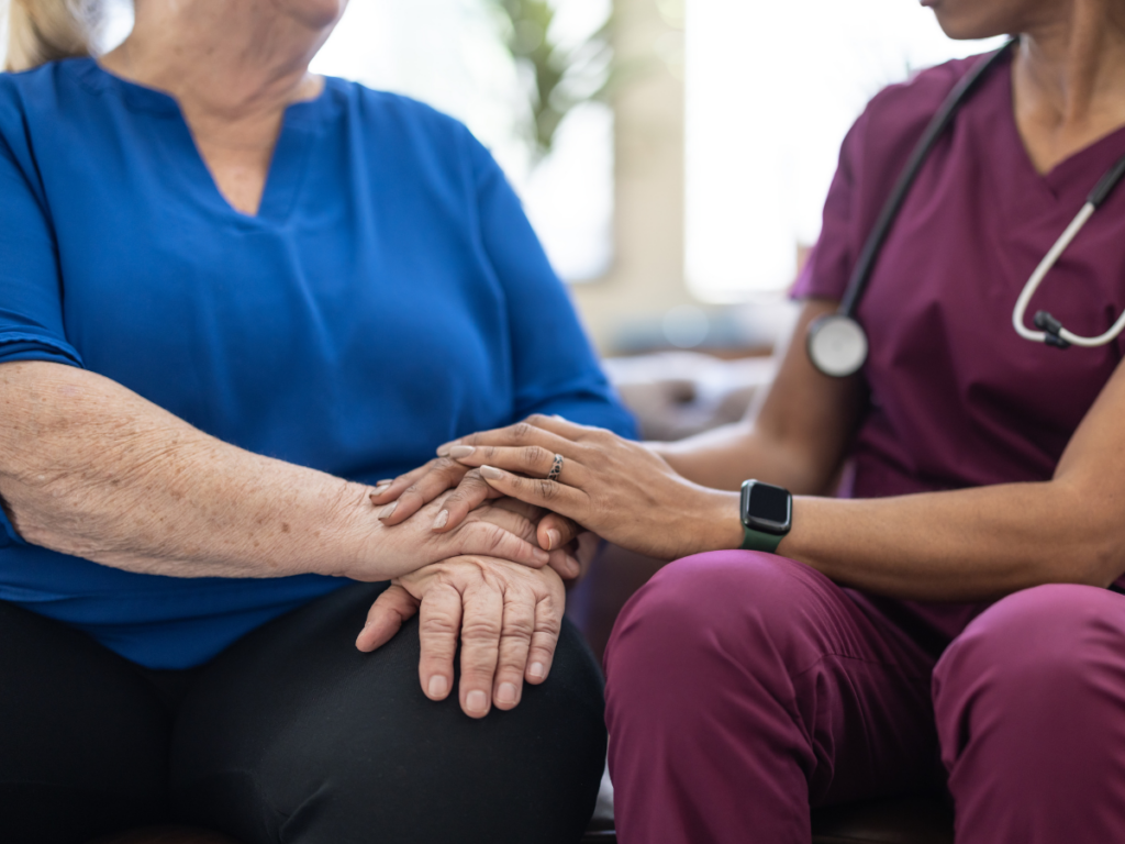 Healthcare professional providing support to a patient during a medical consultation
