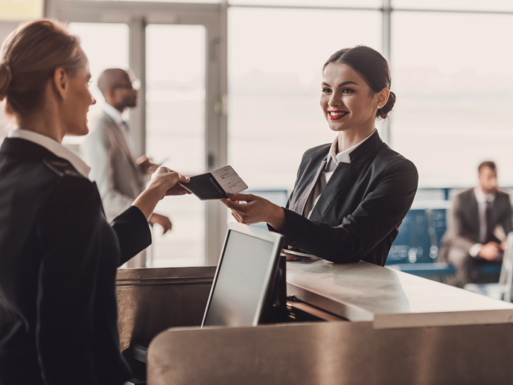 Traveller presenting a passport at an airport check in desk before a flight to Europe